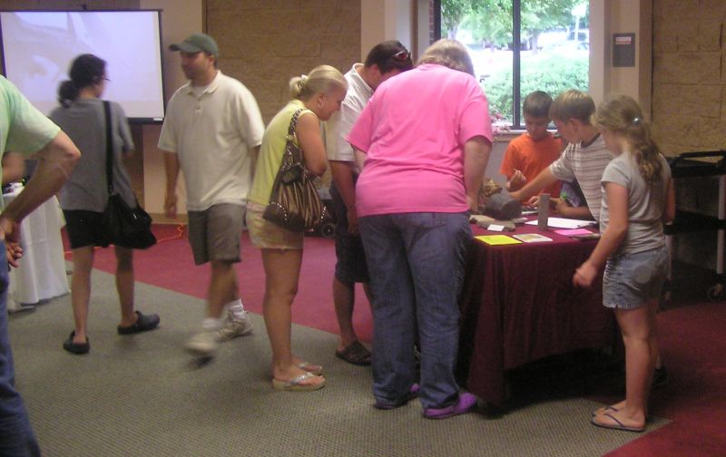 people checking out the fossils