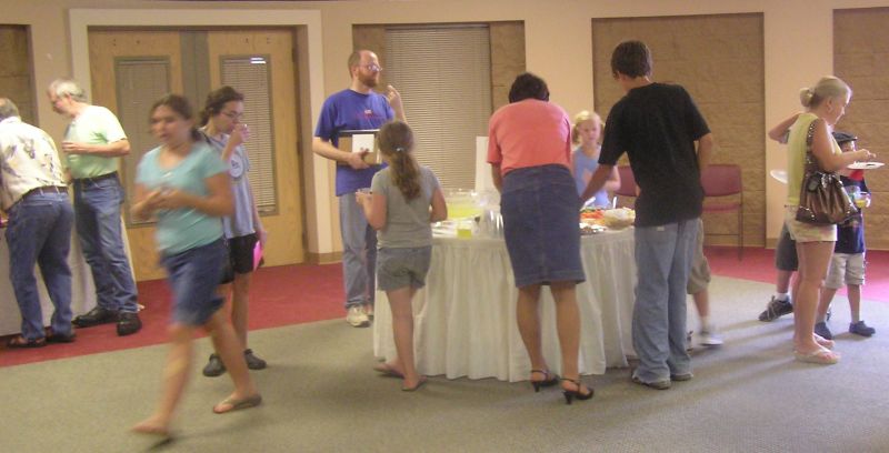 gathered around the food table at fossil display