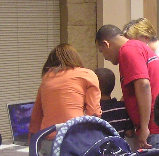 people looking at microscope image fossils