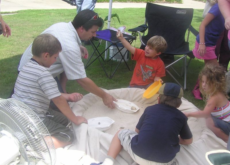 kids finding fossils in sand pile