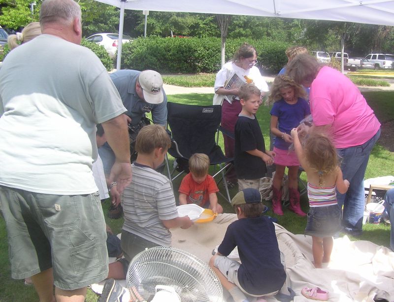 kids finding fossils in sand pile