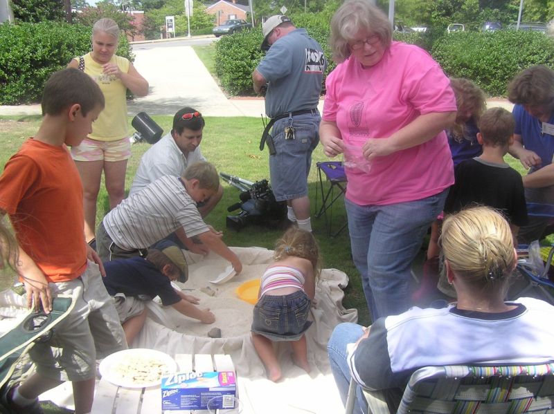 kids finding fossils in sand pile