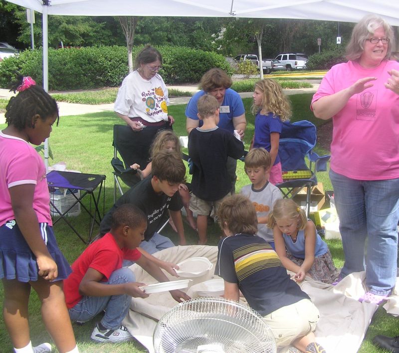 kids hunting fossils in sand pile